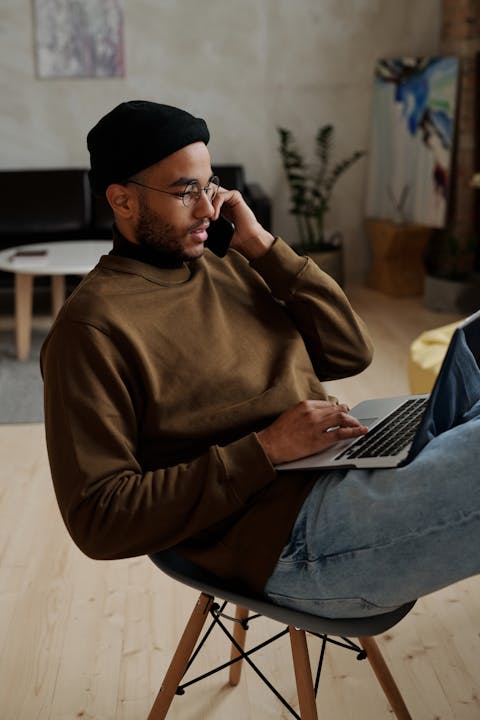 man-in-brown-long-sleeve-shirt-sitting-on-a-chair